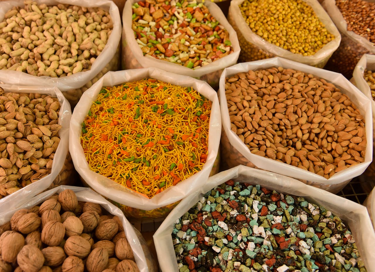Services-01 Variety of nuts and spices displayed in bags, showcasing colorful and diverse food options.